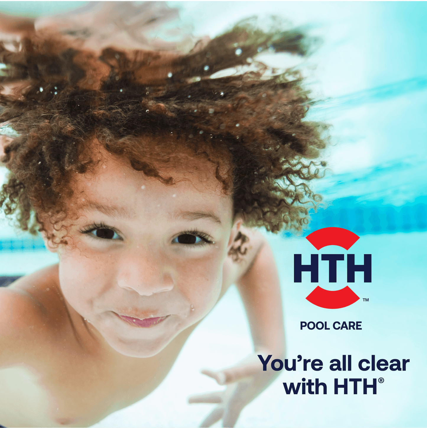 Boy swimming under water with HTH logo in the foreground