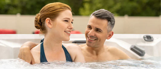 couple sitting close in hot tub after applying hth spa scale preventer