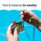 hands use pool water test kit twice weekly
